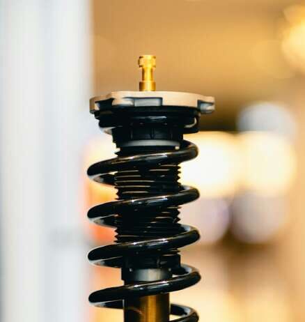 How to Spot When Your Car Needs Suspension Repair: Signs & Costs car suspension strut