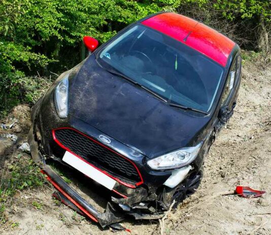 ford in ditch on dirt road