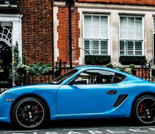 blue porsche in city street