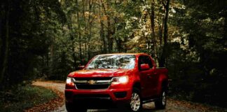 red chevy silverado on forest road